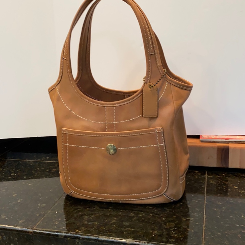 Vintage coach tote with front pocket and three inner pockets.
